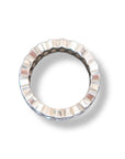 A silver-toned Marquise Diamond Eternity Ring by Nijma M Fine Jewelry, with a wavy, ridged edge, is shown from above on a white background, casting a subtle shadow—evoking the elegance of customizable 18K white gold designs.