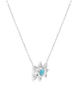 The Small White Gold Evil Eye Necklace by Nijma M Fine Jewelry features a turquoise gemstone pendant in an eye-shaped design layered over a six-pointed star, hanging from a thin, elegant chain. Set against a plain white background.