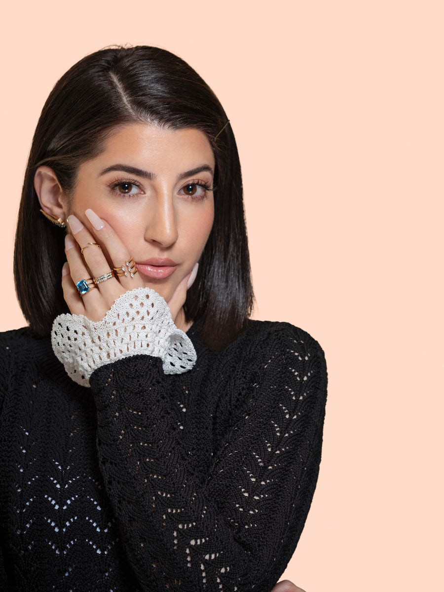 Model wearing a set of diamond and blue topaz diamond rings