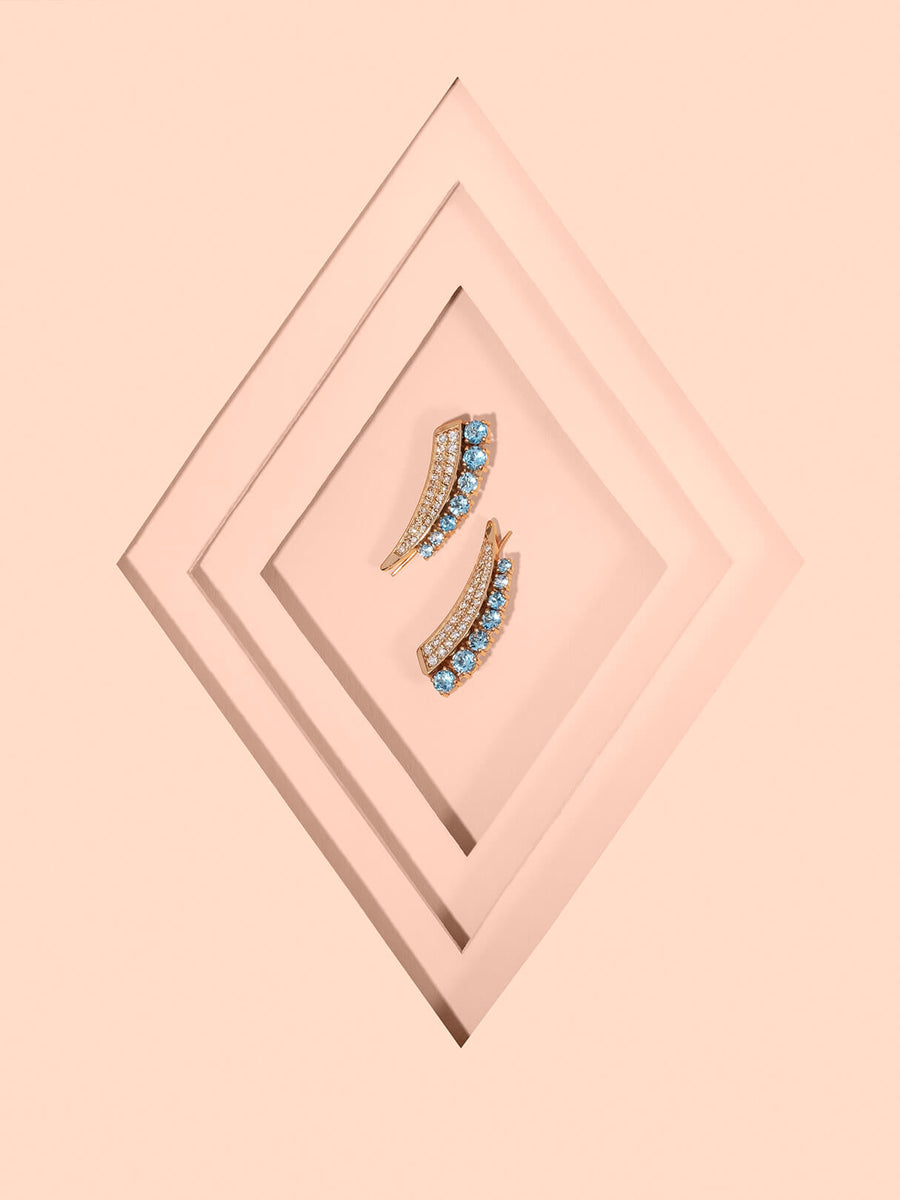 Stylized jewelry photography.  Blue topaz, yellow gold earrings 