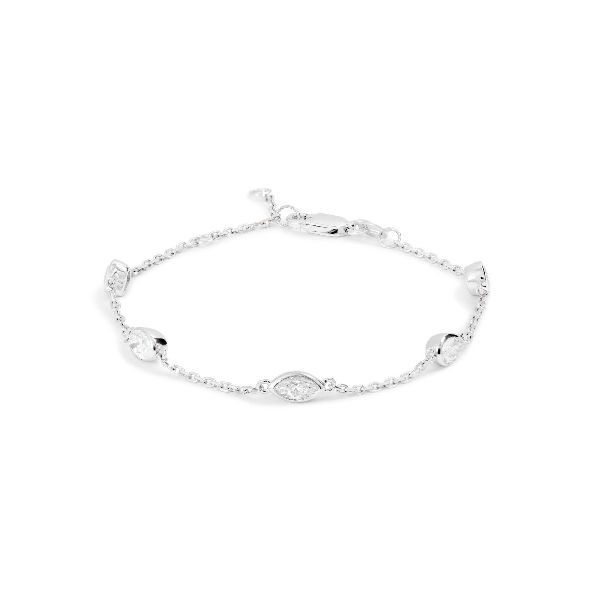 The Nijma M Fine Jewelry White Gold Diamond Station Bracelet features five oval and round natural diamonds in 18K white gold, set evenly in a station design and finished with a secure lobster clasp.