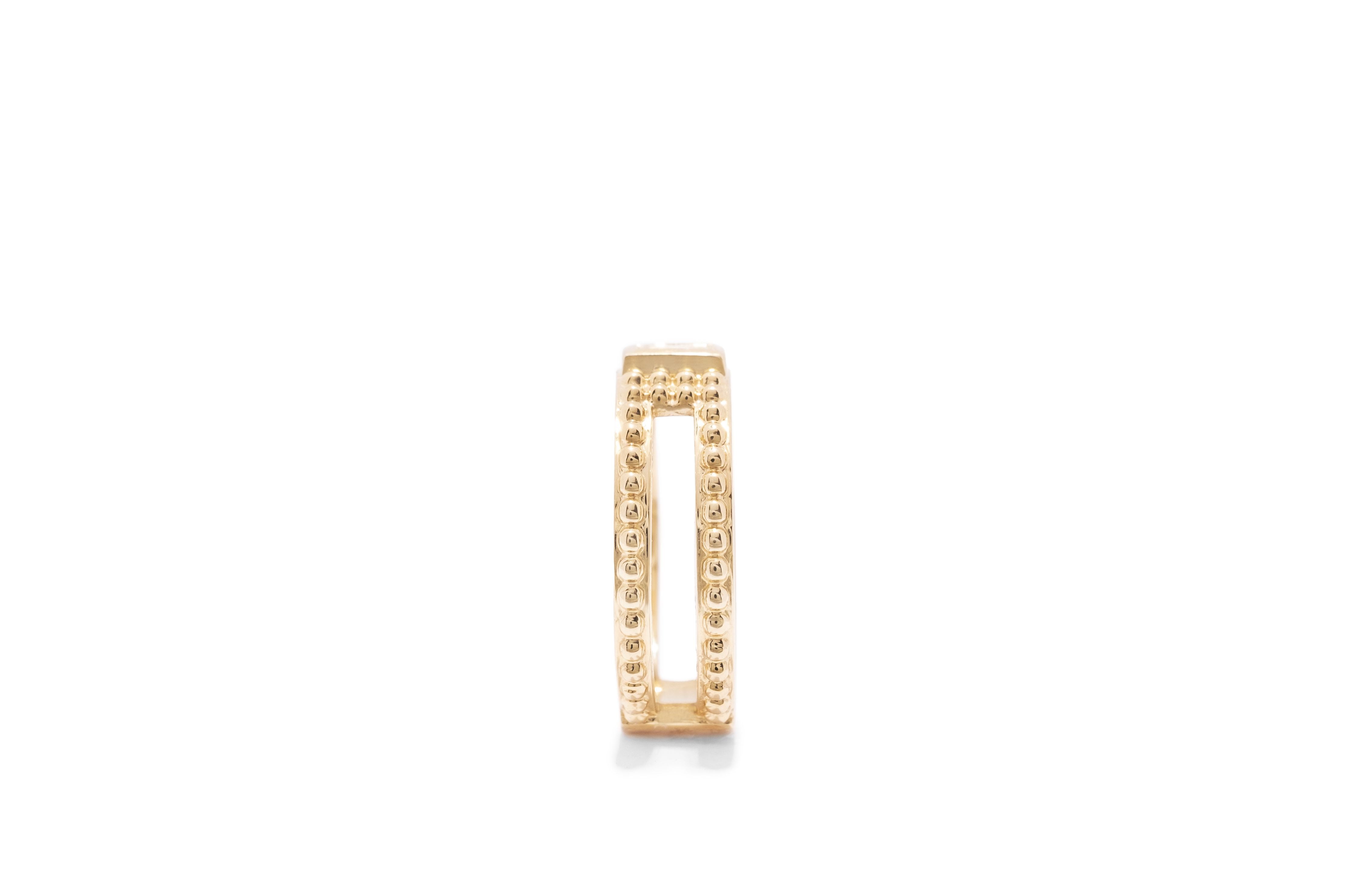 yellow gold single baguette diamond ring with gold bead detail and cutouts