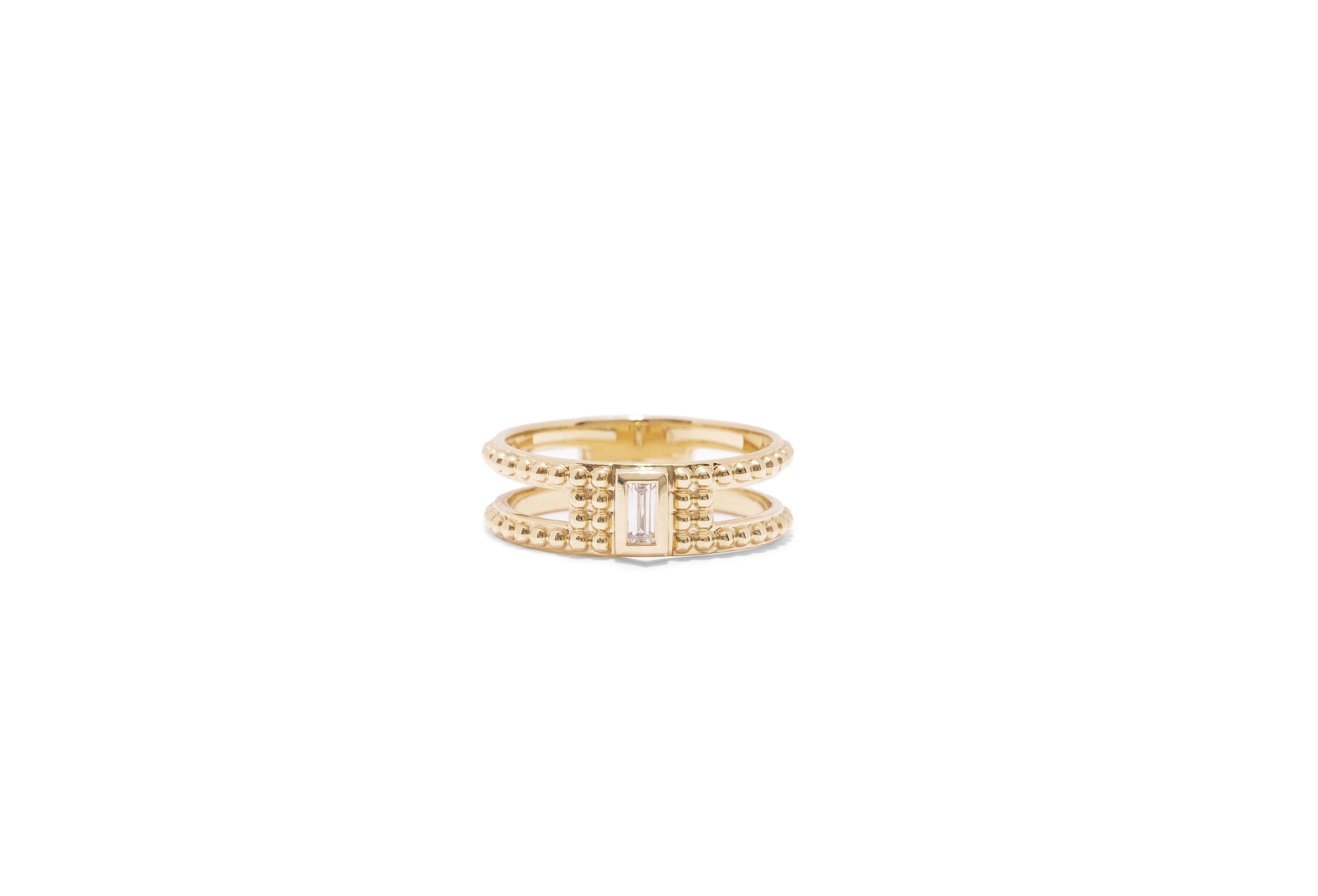 yellow gold single baguette diamond ring with gold bead detail and cutouts
